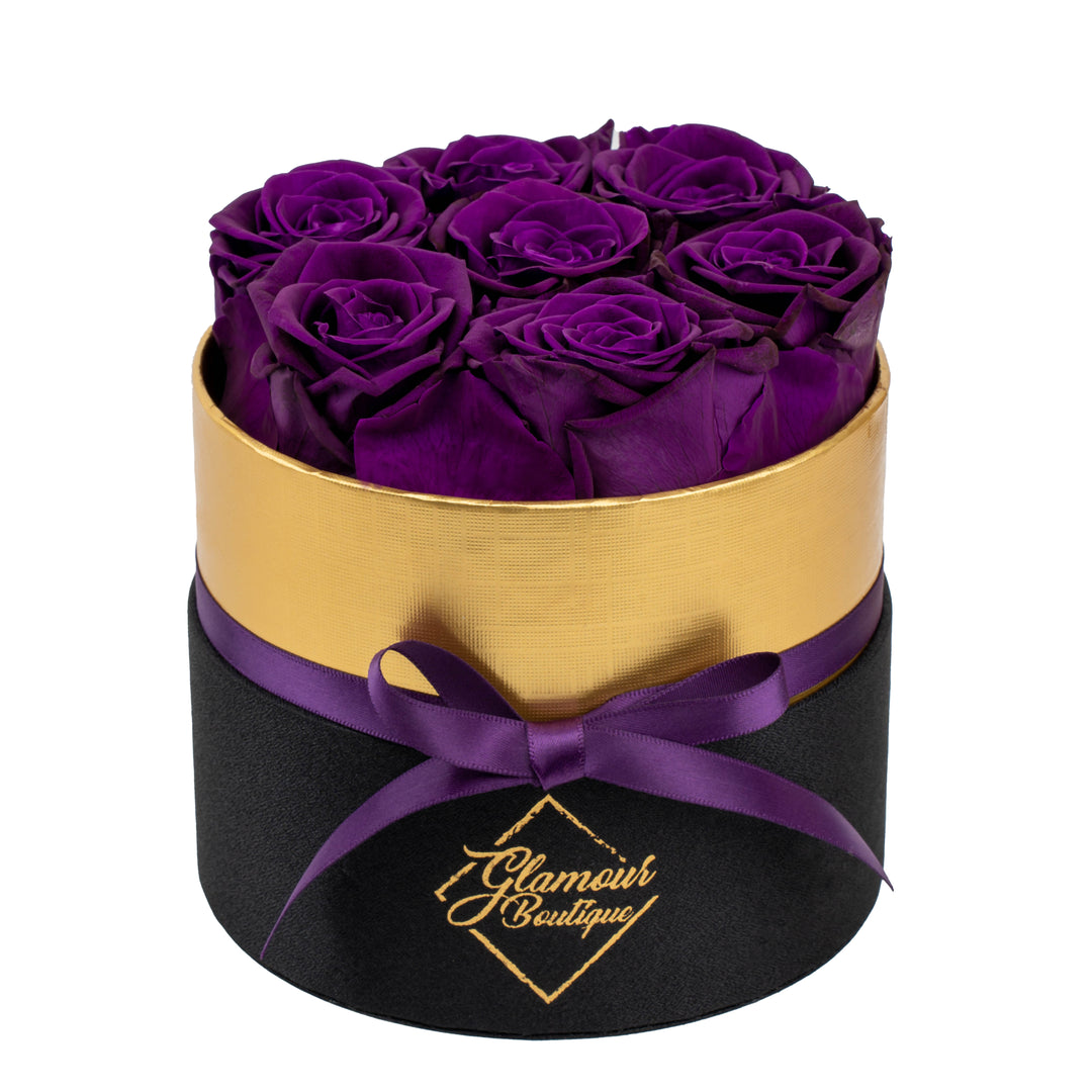Lasting Beauty round black gold box with 7 purple preserved roses by Glamour Boutique