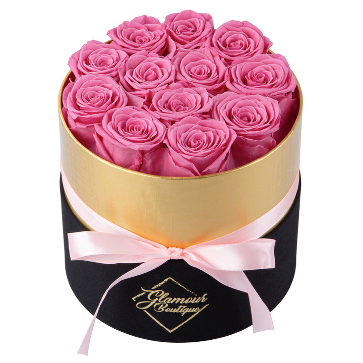 Lasting Beauty round black gold box with 12 pink preserved roses by Glamour Boutique