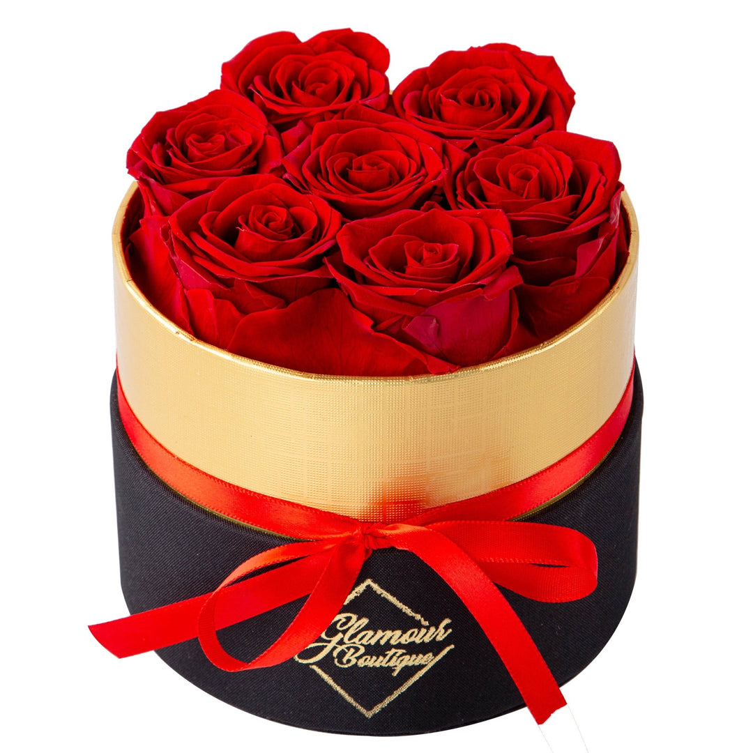 Lasting Beauty round black gold box with 7 red preserved roses by Glamour Boutique
